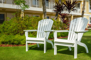 Empty Adirondack Chairs in a Private Garden