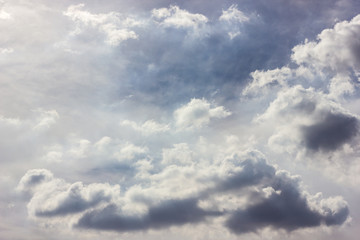 Fluffy clouds backlit scenery.