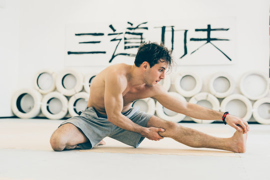 Man touching toes doing leg stretching exercises
