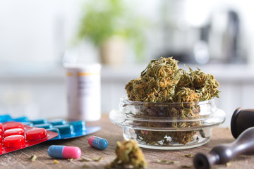 Marijuana buds in the glass plate and medications