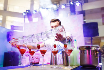 Barman show. Bartender pours alcoholic cocktails.