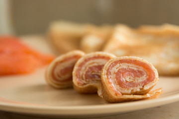 Rolled pancakes with smoked salmon