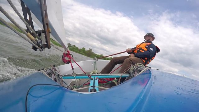man drives sports yacht