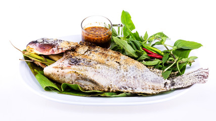 Grilled fish with salt on white plate