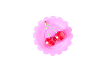 Cherry on a bright saucer isolated white