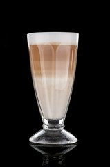 Fancy latte coffee in glass jar over black background