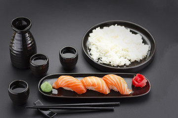 Japanese cuisine. Sushi roll with soy sauce over black background.