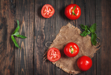Close-up of fresh, ripe tomatoes on wood background