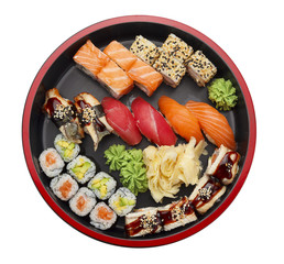 Japanese cuisine. Sushi set on a round plate isolated on white background.