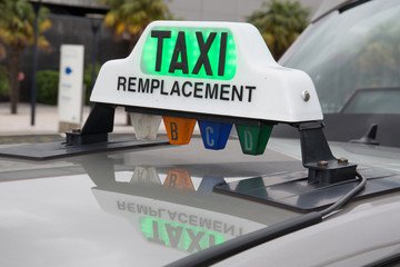 Green taxi sign in France on the car