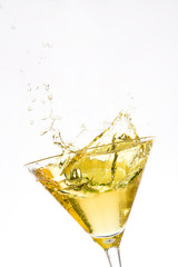 Yellow cocktail splash isolated on white background
