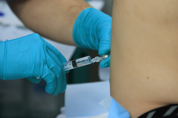 Making a spinal anesthesia injection with syringe close-up
