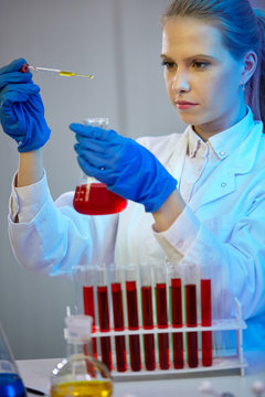 female scientific carrying out research in a chemistry lab.