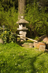stone sculpture in Japanese garden in spring