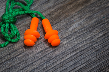 Ear plugs  on wooden background