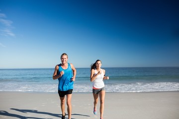 Friends jogging at the beach