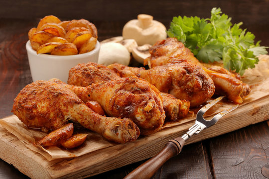 Roasted chicken legs with potato chips and vegetables