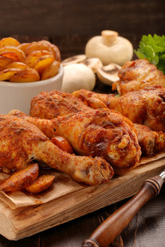 Roasted chicken legs with potato chips and vegetables