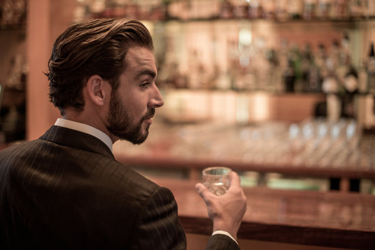 Businessman Drinking Spirits At Hotel Bar