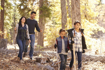 Close up of happy Hispanic family hiking in forest, close up