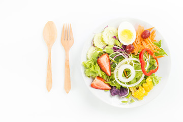 Fresh healthy salad dish with wooden spoon and fork. Isolated on