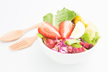 Fresh healthy salad bowl with wooden spoon and fork. Isolated on