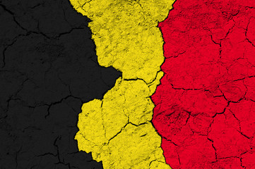 Flag of Belgium on rugged wall full of scratches - metaphor of problem and crisis leading to...