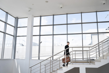 Side view of man walking up the stairs