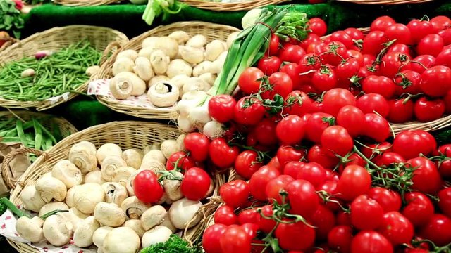 Fresh tomatoes and mushrooms in a basket