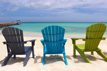 Fototapeta na wymiar Colorful beach chairs on Caribbean coast