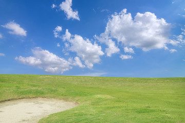Fototapeta na wymiar golf course - green golf field and sand pit with sky blue cloud
