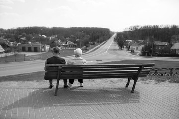 Older men sit on a bench - obrazy, fototapety, plakaty