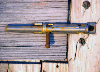 Rusty iron handle on an old wooden door