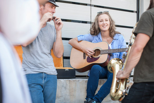 Three street musicians playing together