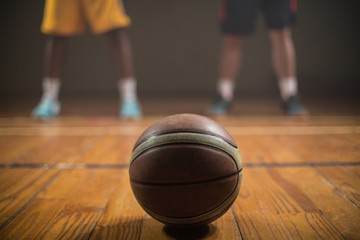 Naklejka premium Close up on basketball putting on the floor 