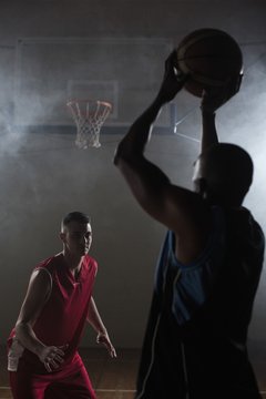 Portrait of two men playing basketball