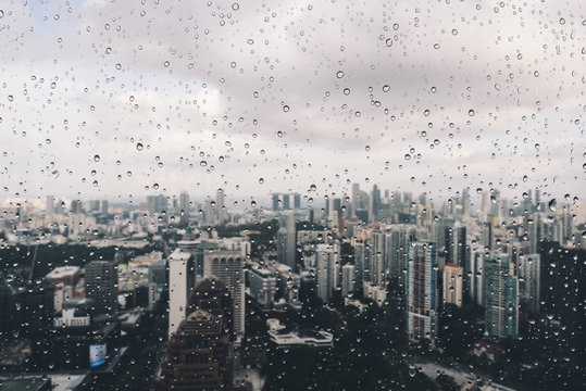After the rain - Raindrops on a window overlooking the cityscape.