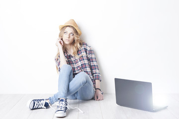 A bored girl sitting on the floor with notebook