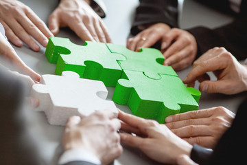 Business people assembling puzzle
