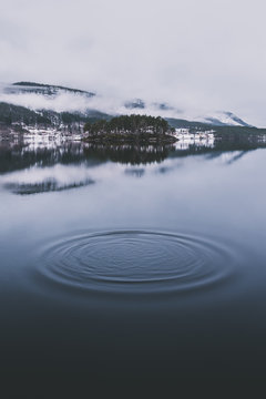 Ripples on lake - Atmospheric ripples on still lake reflecting on tree island.