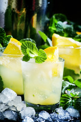 Iced cocktail with mint, orange, lemon, vodka and crushed ice, s
