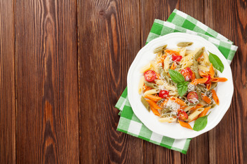 Colorful penne pasta with tomatoes and basil