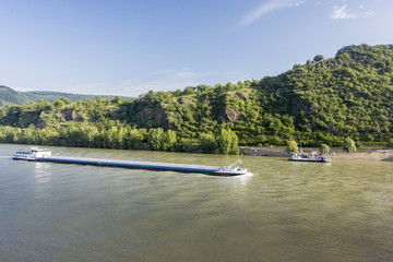 Cargo ship and car ferry on the river Rhine, Germany