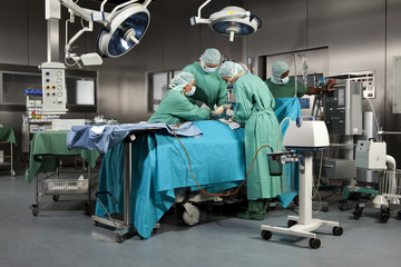 Doctors and nurses operating on a patient in a operating room