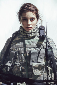 Portrait of army soldier standing against white background