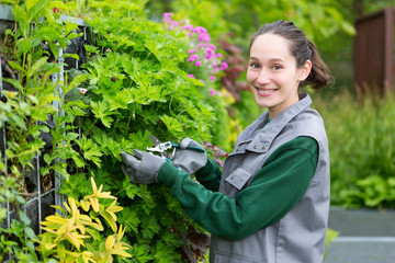 Young attractive woman working in a public garden