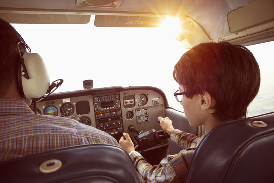 Father and son in cockpit of private airplane