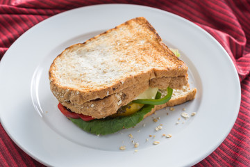 Food series : Egg sandwich whole wheat bread on white plate