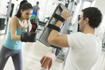 Fototapeta na wymiar Young woman boxing in the gym