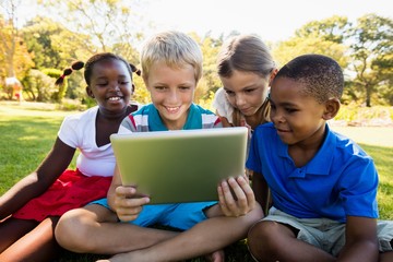 Kids using technology during a sunny day